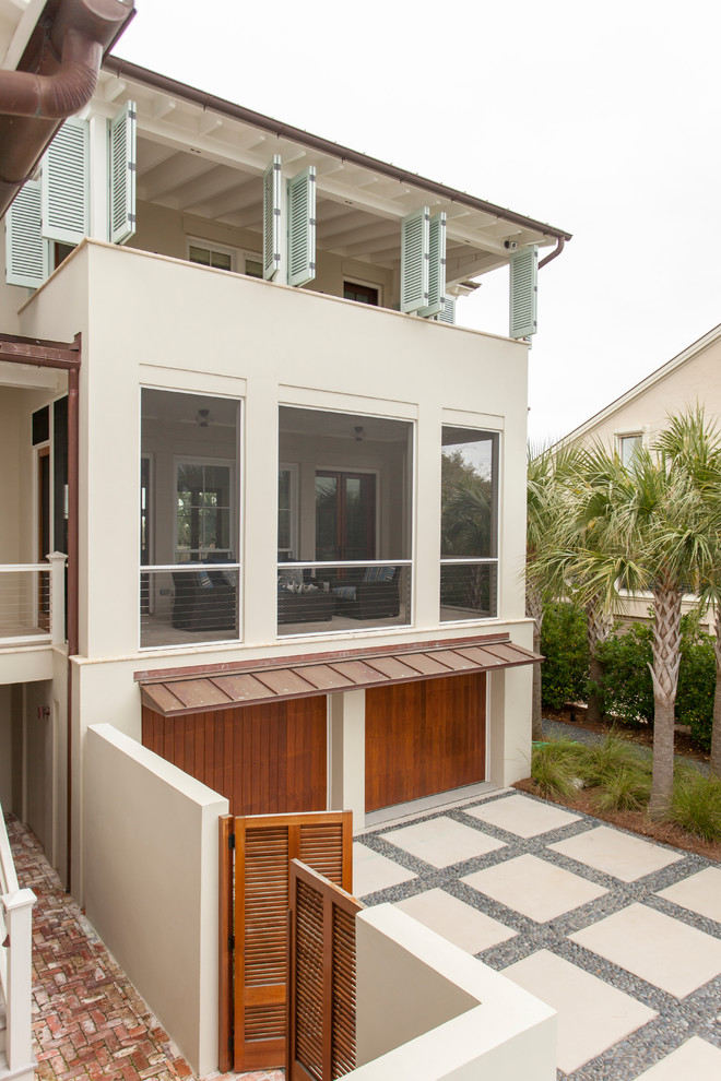 Example of a beach style white two-story mixed siding exterior home design in Charleston with a hip roof