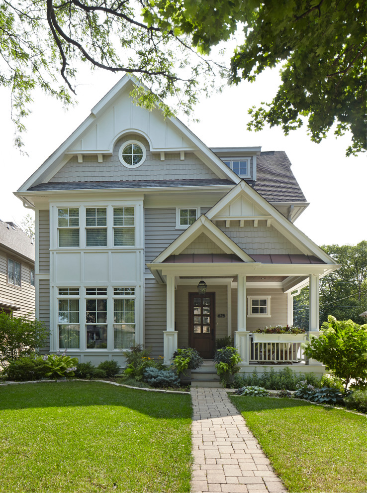Mid-sized elegant two-story vinyl gable roof photo in Chicago