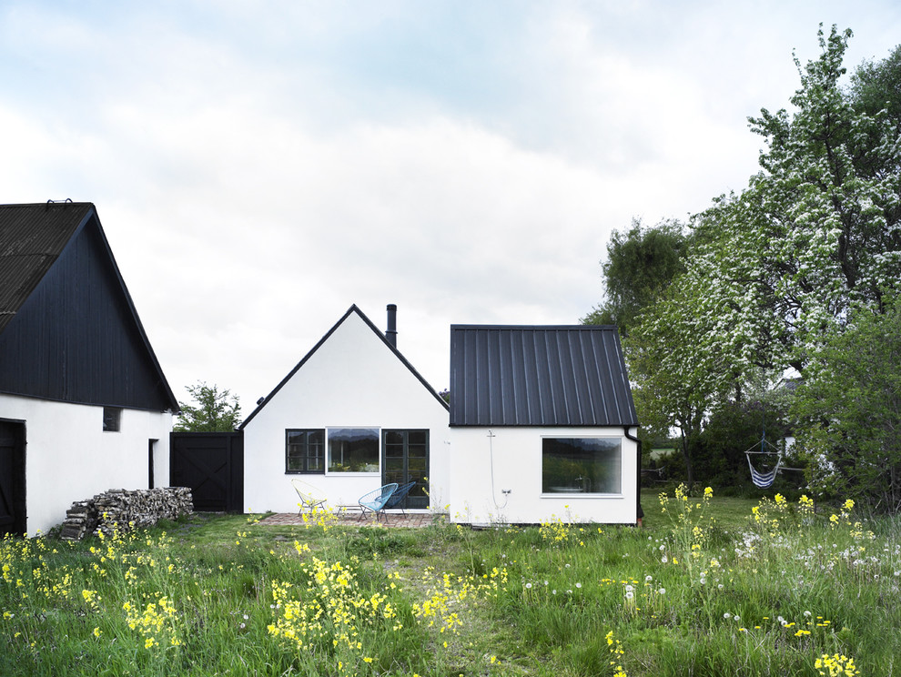 Danish two-story exterior home photo in Copenhagen with a metal roof