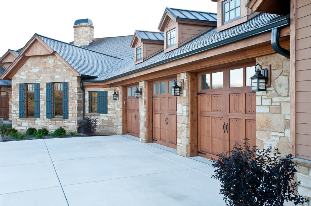 Large and brown traditional bungalow house exterior in Milwaukee with stone cladding.