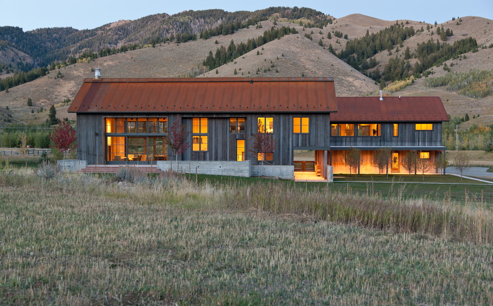 Rustic two floor house exterior in Boise with wood cladding and a metal roof.