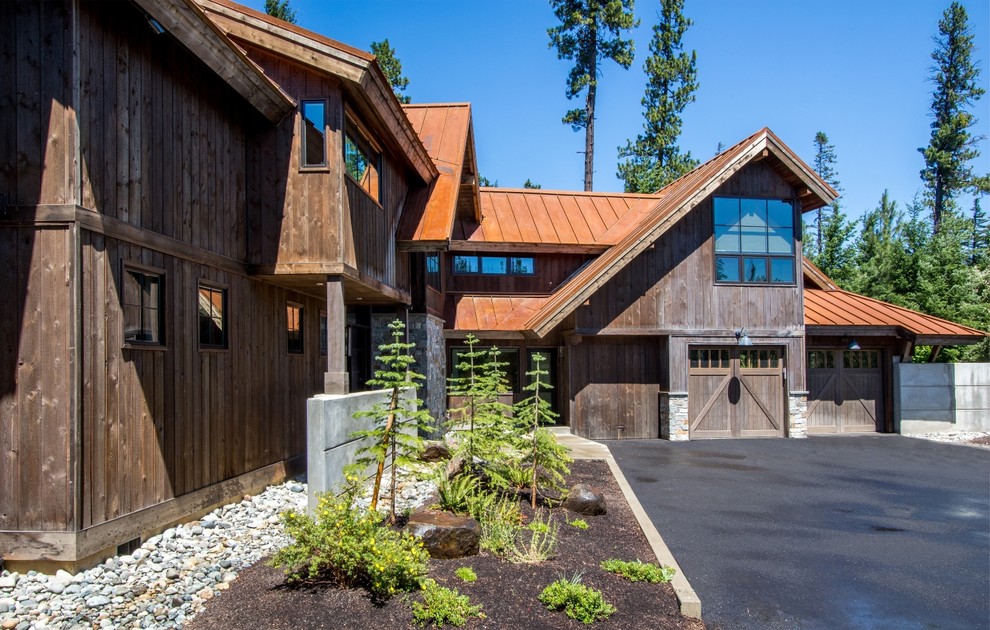 Inspiration for a rustic brown two-story mixed siding house exterior remodel in Seattle with a metal roof