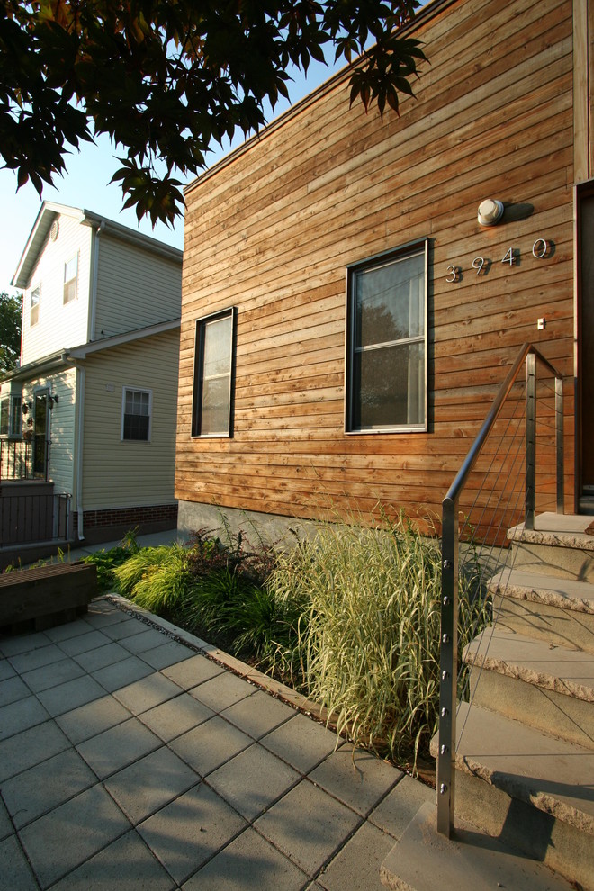 Design ideas for a contemporary house exterior in New York with wood cladding.