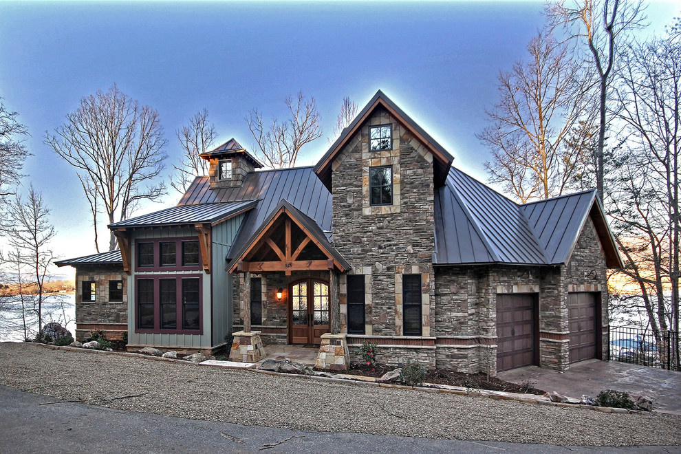 Inspiration for a mid-sized rustic brown two-story stone house exterior remodel in Atlanta with a hip roof and a metal roof