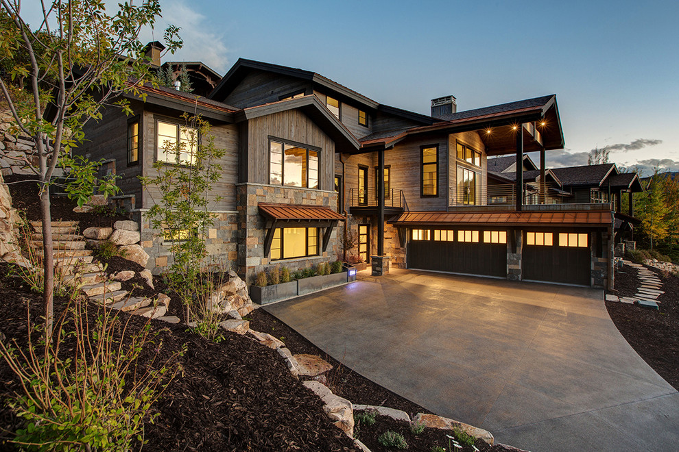 Inspiration for a brown rustic house exterior in Salt Lake City with three floors, mixed cladding and a pitched roof.