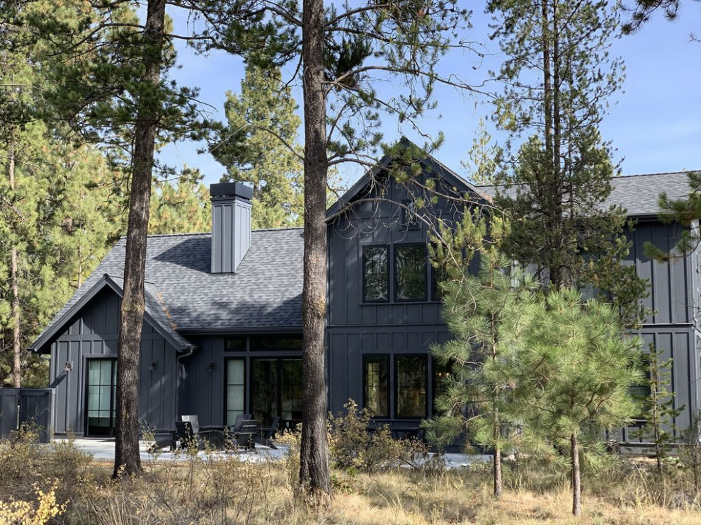 Large country black two-story wood exterior home photo in Salt Lake City with a mixed material roof