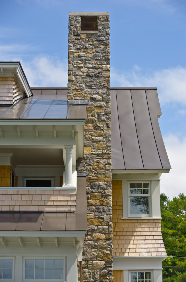 Inspiration for a large timeless two-story wood house exterior remodel in Burlington with a metal roof