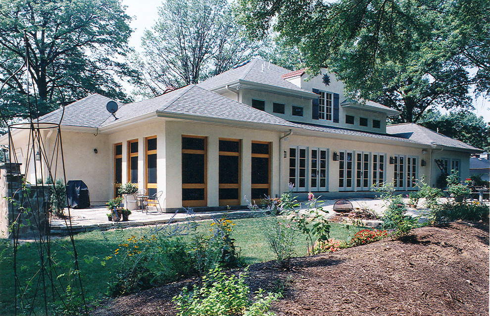 Inspiration for a mediterranean beige two-story stucco exterior home remodel in St Louis