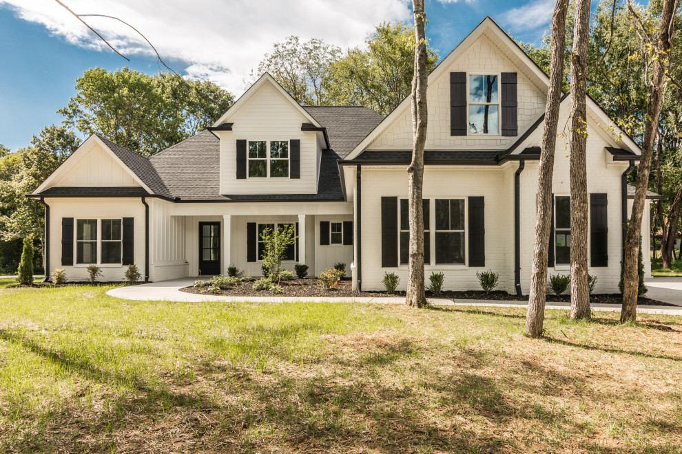 Inspiration for a large farmhouse white two-story mixed siding exterior home remodel in Nashville with a shingle roof