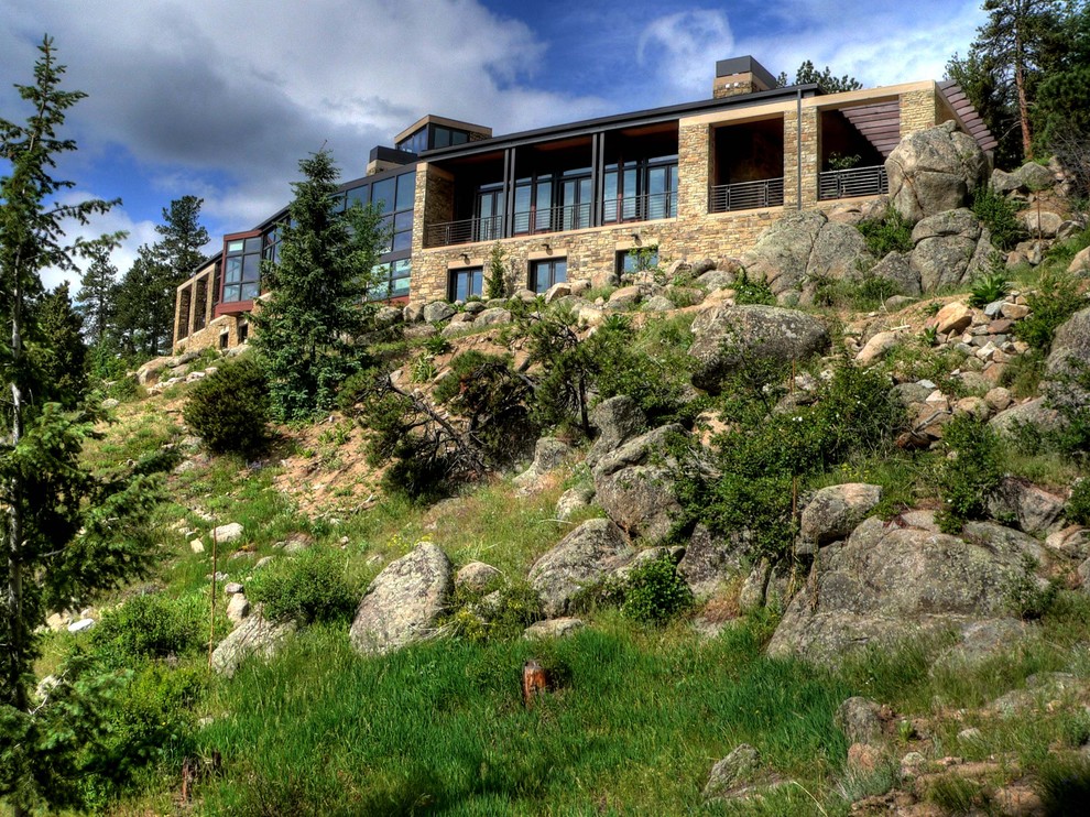 Expansive rustic two floor house exterior in Denver with stone cladding.