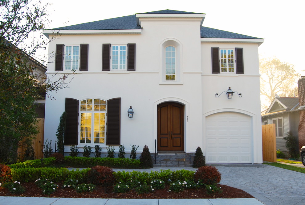 Immagine della facciata di una casa bianca classica a due piani con rivestimento in stucco