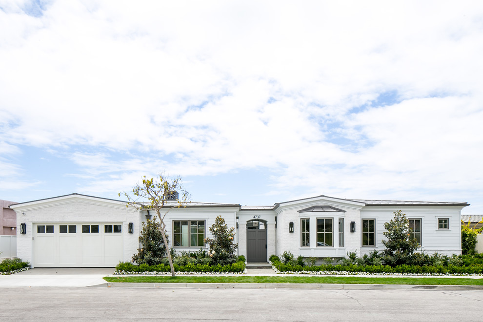 This is an example of a white and large classic bungalow detached house in Orange County with mixed cladding.