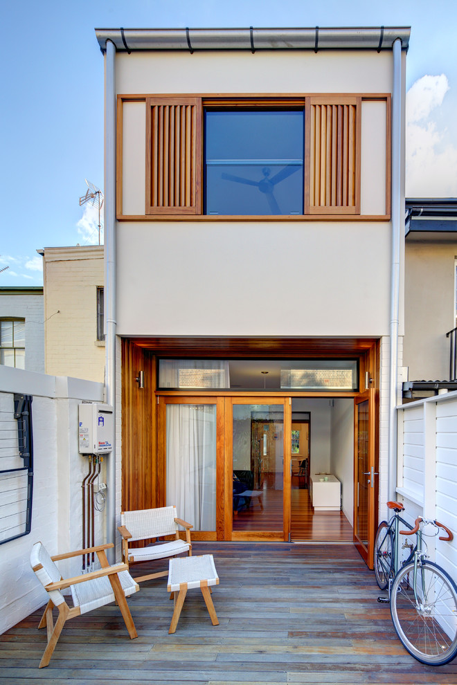 Inspiration for a modern beige two-story exterior home remodel in Other