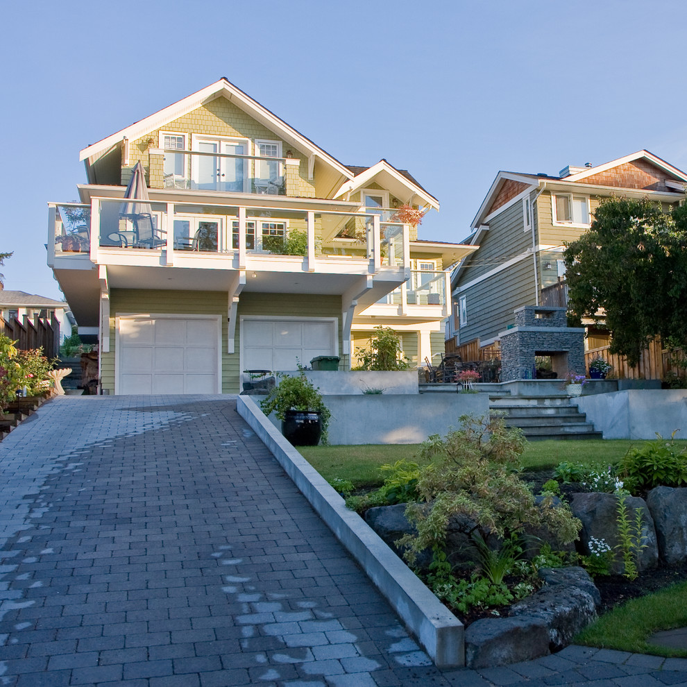 Large traditional yellow three-story wood exterior home idea in Vancouver with a shingle roof