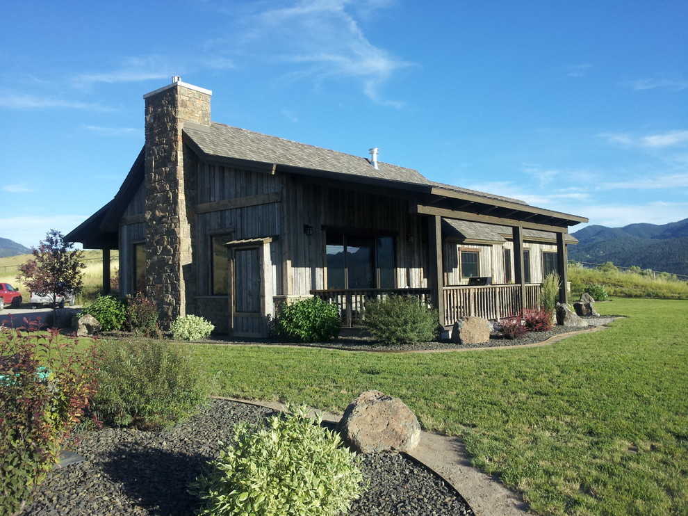 Example of a mid-sized mountain style gray one-story wood exterior home design in Boise with a mixed material roof
