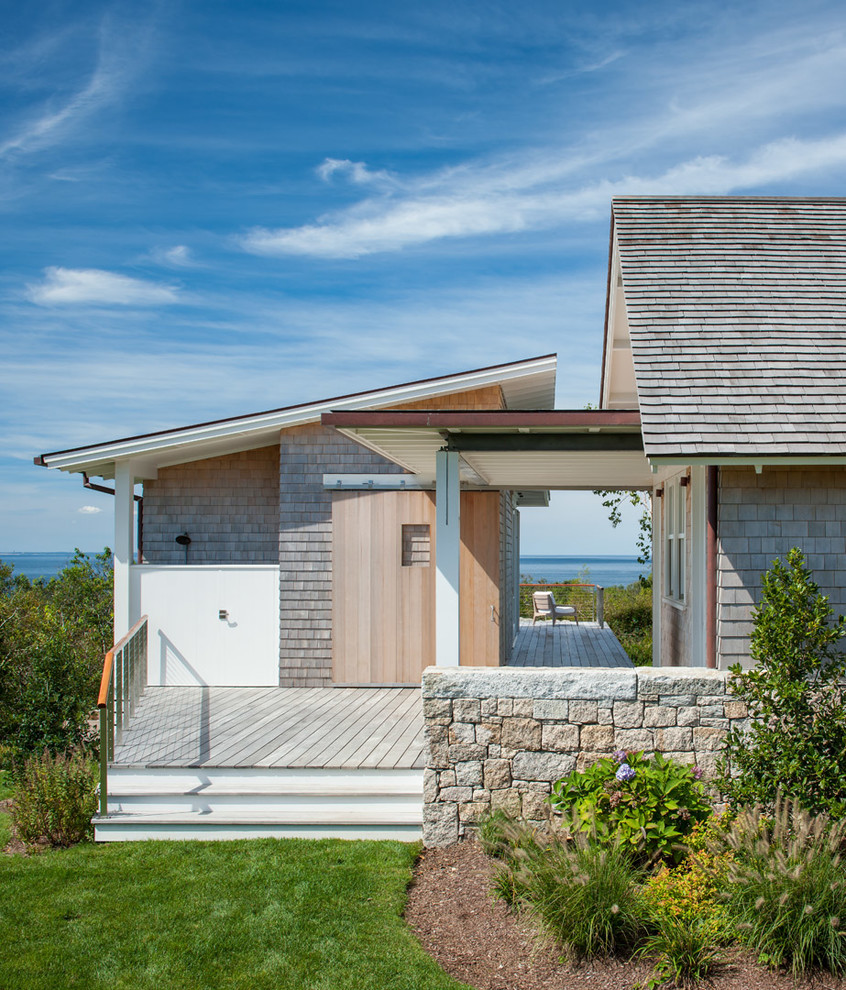 Design ideas for a coastal house exterior in Providence with wood cladding.