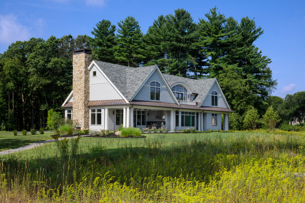 Inspiration for a large cottage gray two-story exterior home remodel in Boston with a mixed material roof