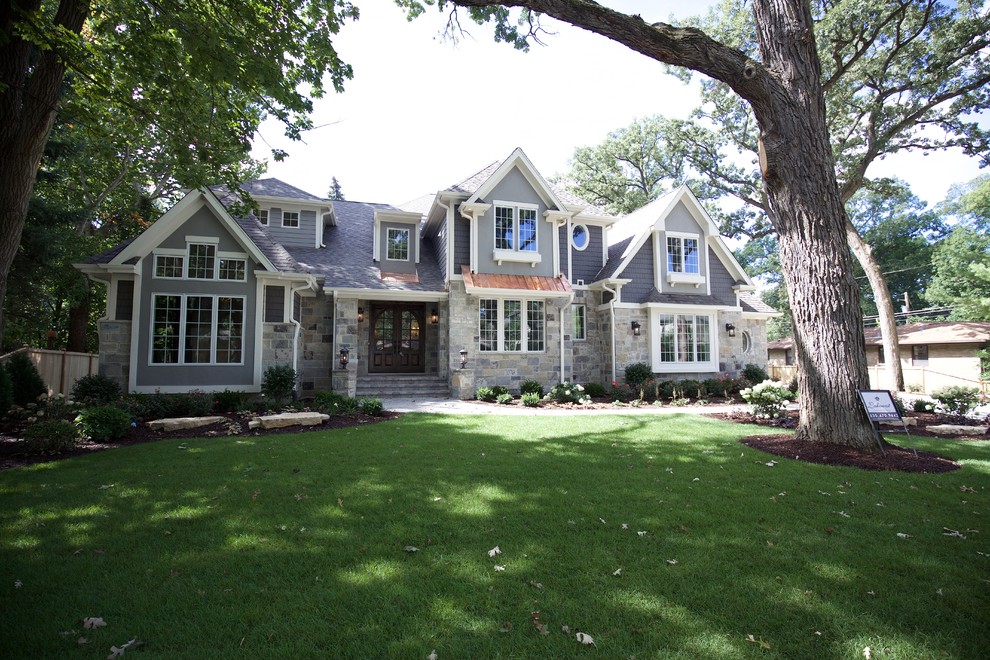 Inspiration for a huge timeless gray two-story stone exterior home remodel in Chicago with a mixed material roof