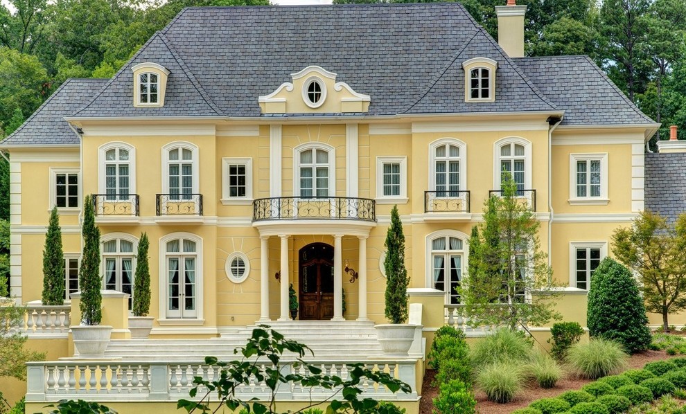 Elegant yellow two-story exterior home photo in Atlanta