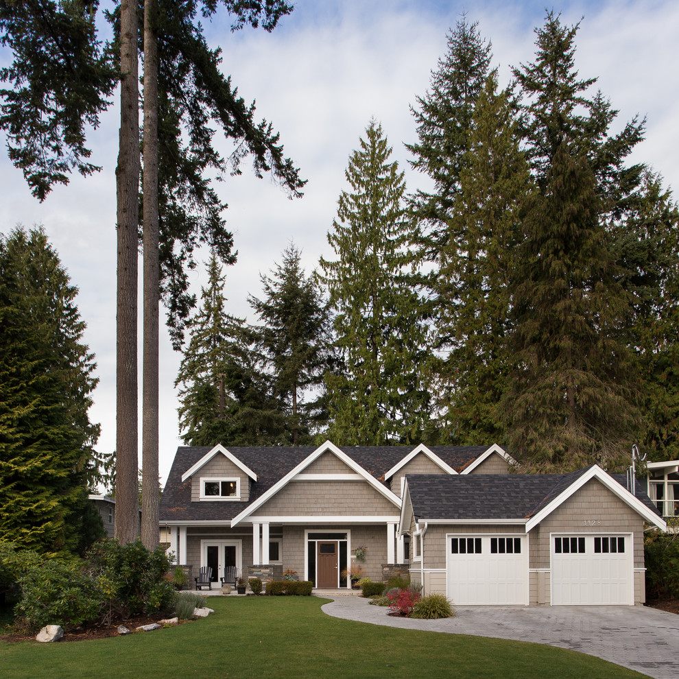 Inspiration for a large transitional beige two-story wood exterior home remodel in Vancouver with a shingle roof
