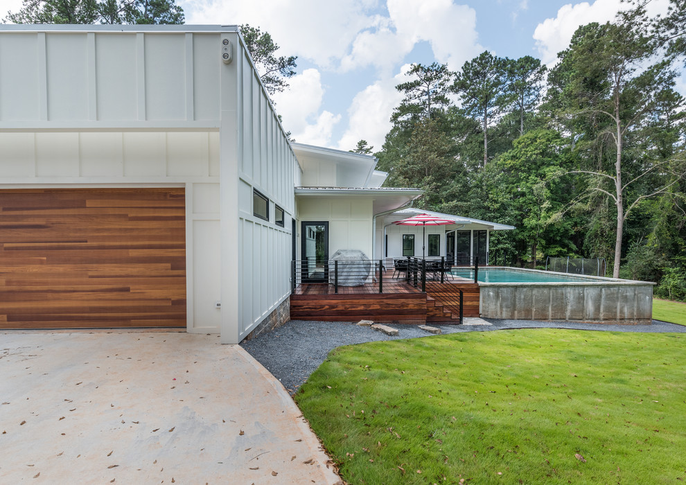 Inspiration for a large and white modern bungalow detached house in Atlanta with concrete fibreboard cladding, a lean-to roof and a metal roof.