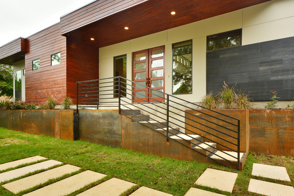 Design ideas for a large modern bungalow house exterior in Austin with mixed cladding.
