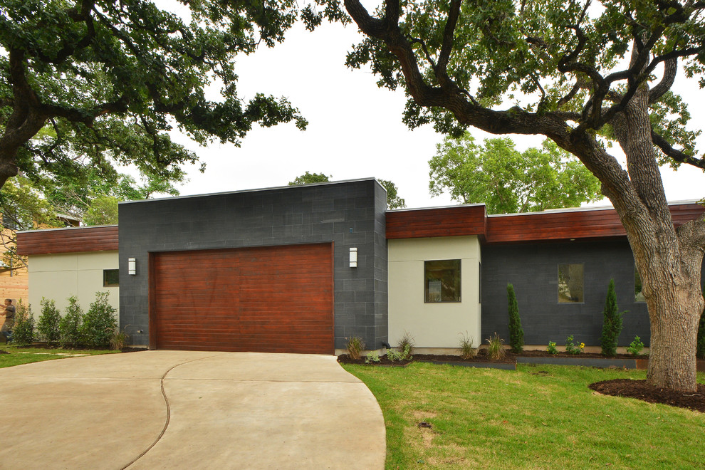 Design ideas for a large modern bungalow house exterior in Austin with mixed cladding.