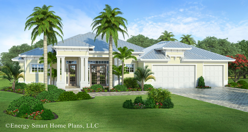 Inspiration for a mid-sized tropical yellow one-story vinyl exterior home remodel in Miami with a hip roof