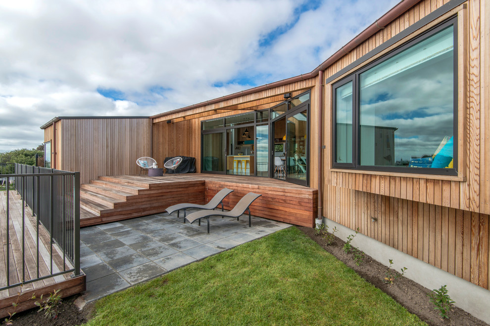 Inspiration for a large contemporary split-level wood exterior home remodel in Christchurch