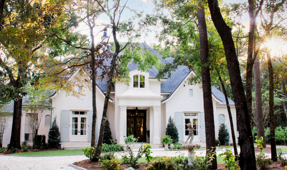 Design ideas for a white traditional two floor brick house exterior.