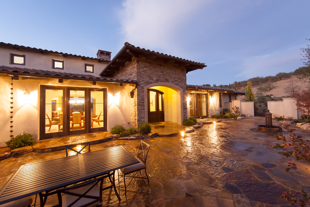 Large tuscan beige one-story stucco exterior home photo in San Luis Obispo with a hip roof