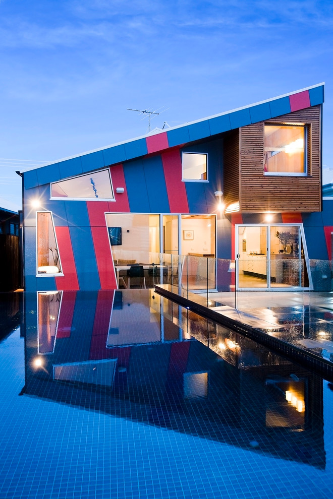 Example of a trendy two-story exterior home design in Melbourne with a shed roof