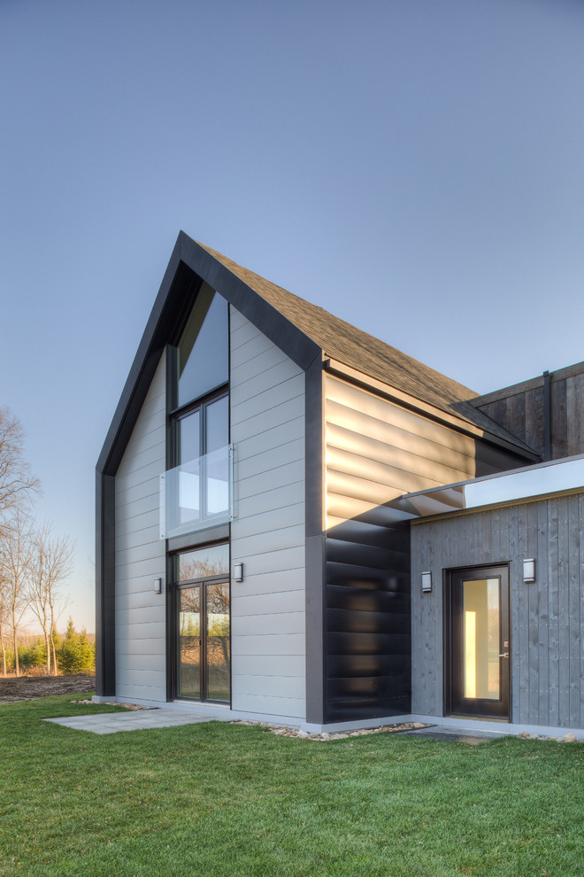 Large minimalist gray two-story metal gable roof photo in Toronto