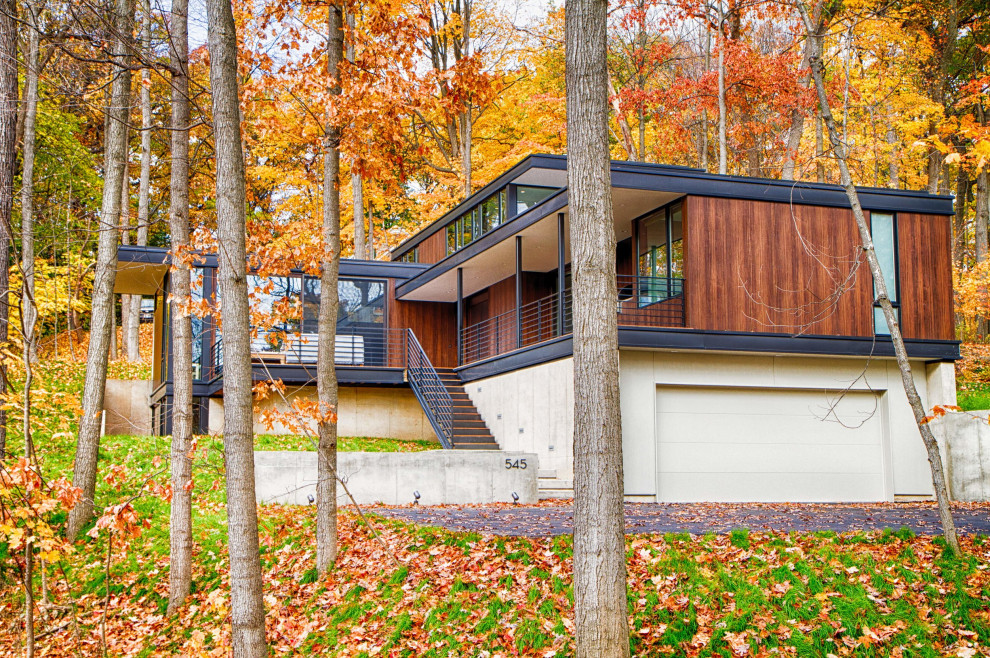 Пример оригинального дизайна: маленький, двухэтажный, деревянный, коричневый частный загородный дом в стиле модернизм с плоской крышей для на участке и в саду