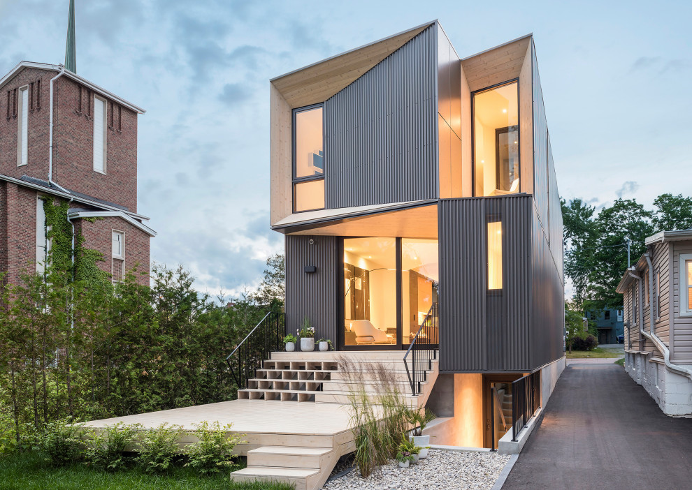 Diseño de fachada de casa gris moderna de tres plantas con tejado plano