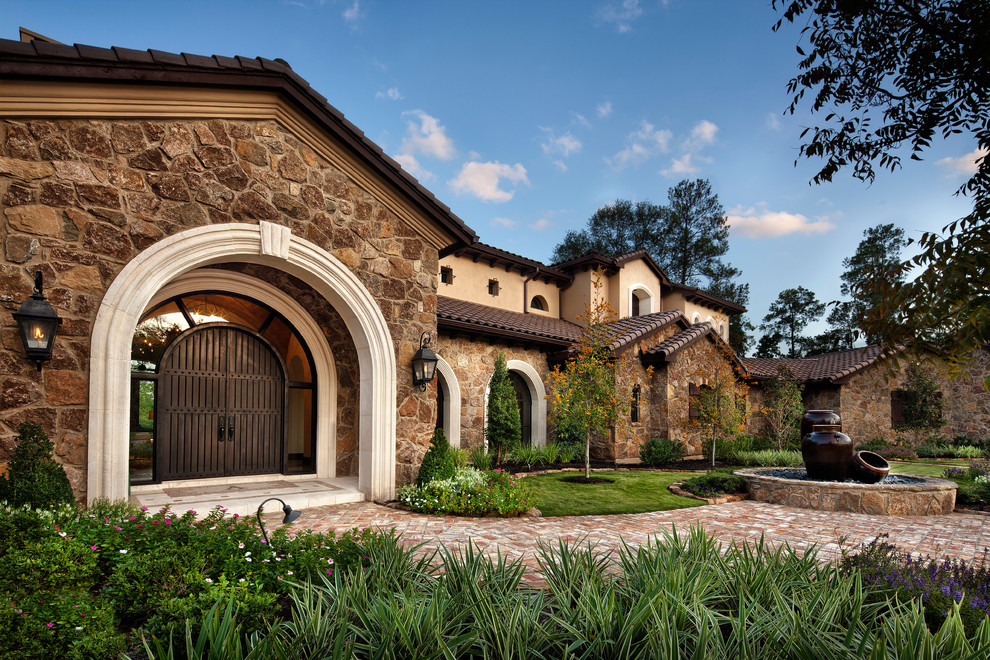 Photo of a mediterranean house exterior in Houston with stone cladding.