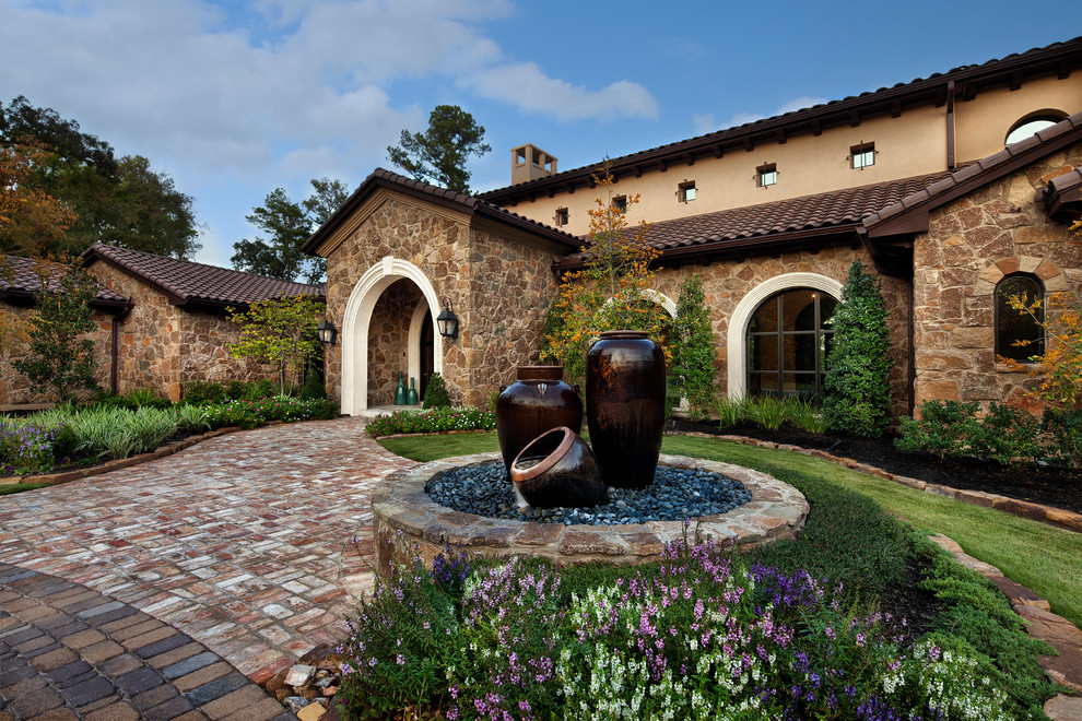 This is an example of a mediterranean house exterior in Houston with stone cladding.