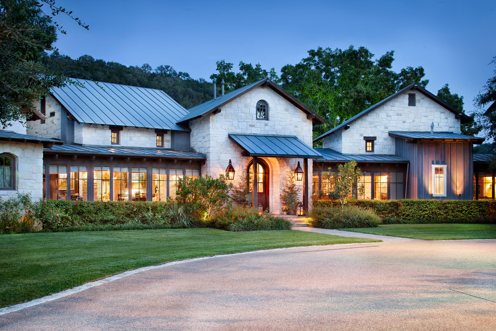Example of a mountain style two-story stone gable roof design in Austin