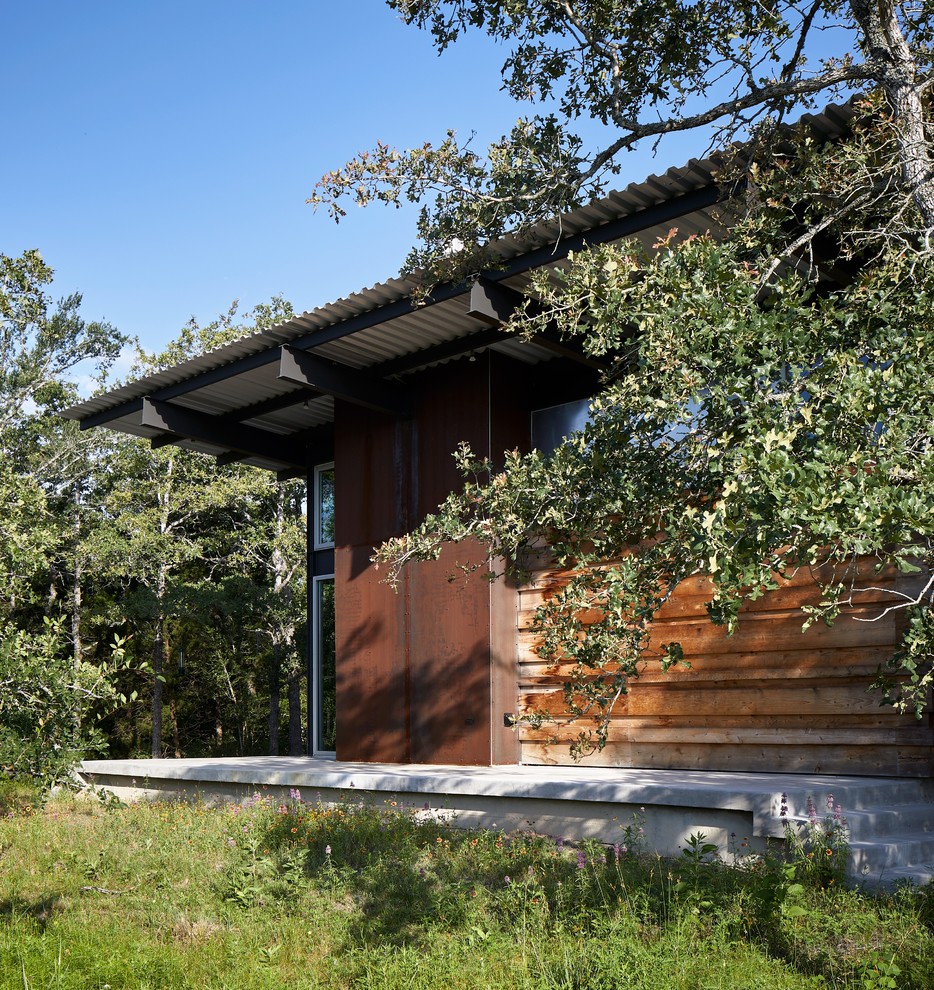 Идея дизайна: одноэтажный частный загородный дом среднего размера в современном стиле с односкатной крышей и металлической крышей
