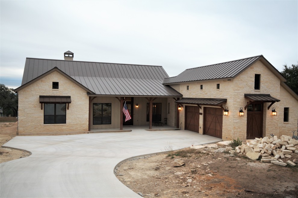This is an example of a medium sized and white traditional bungalow detached house in Austin with stone cladding, a pitched roof and a metal roof.