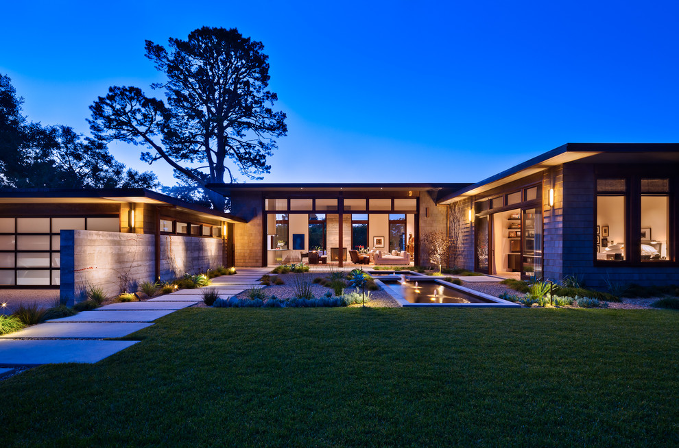 Photo of a contemporary house exterior in Santa Barbara with wood cladding.