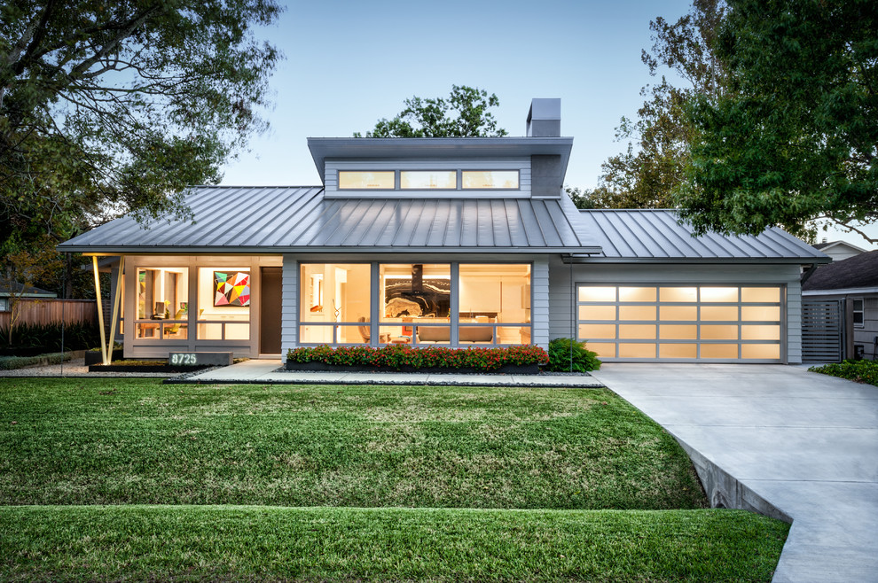 1960s gray one-story concrete fiberboard house exterior photo in Houston with a hip roof and a metal roof
