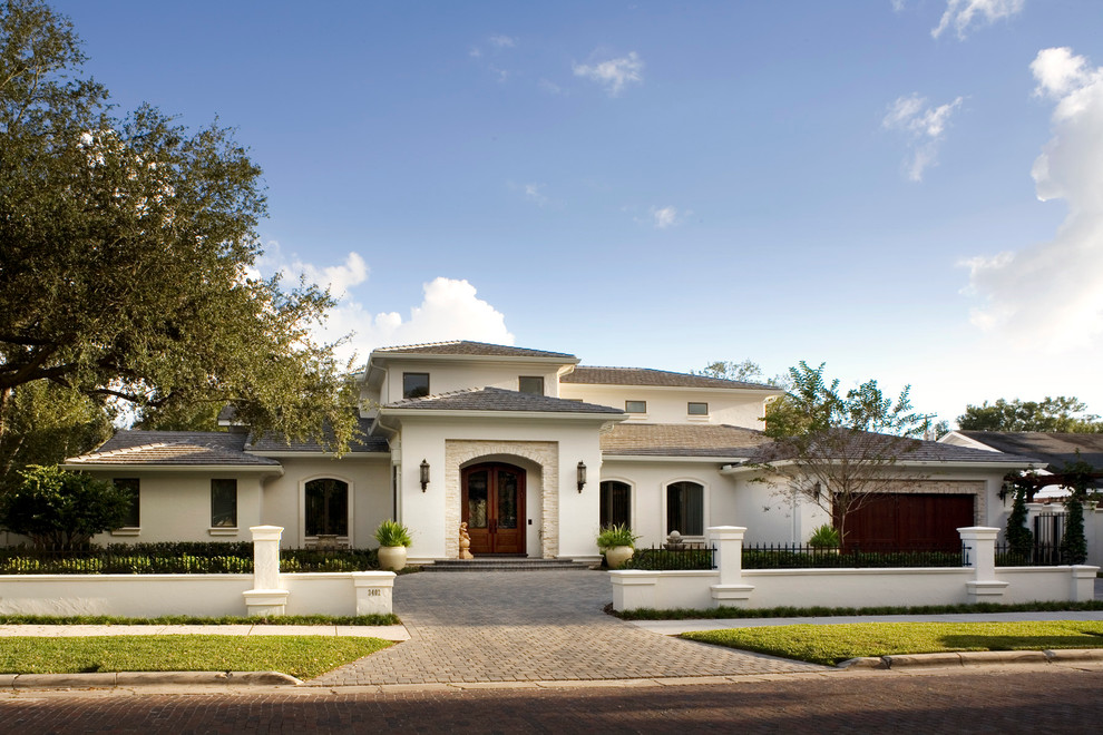 Example of a large trendy white two-story house exterior design in Tampa with a shingle roof and a gray roof