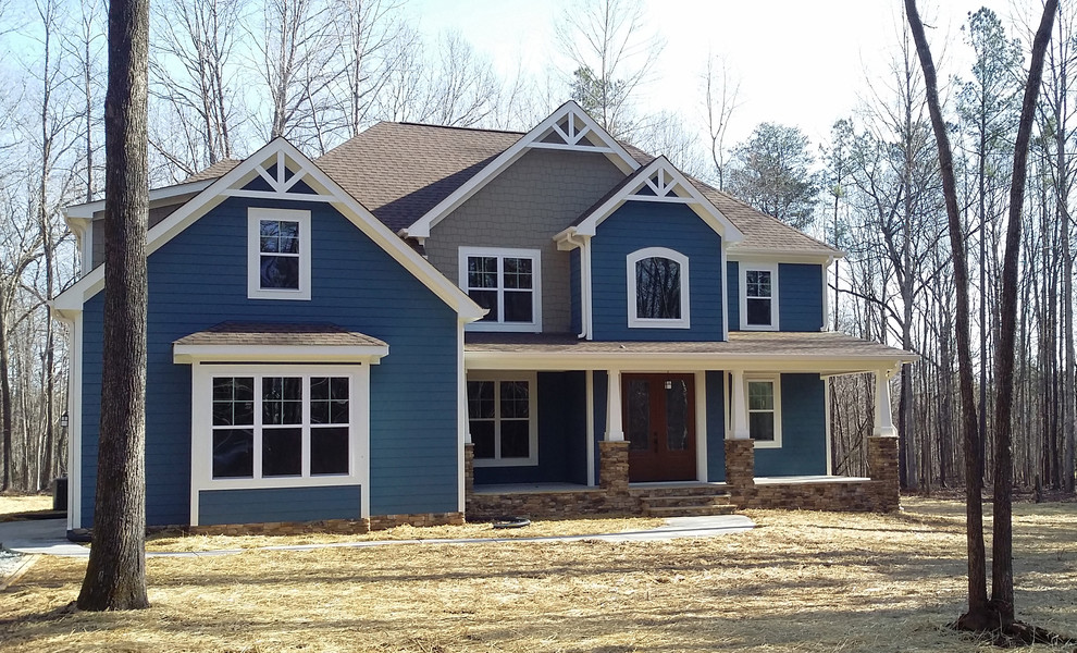 Large elegant blue two-story mixed siding gable roof photo in Raleigh