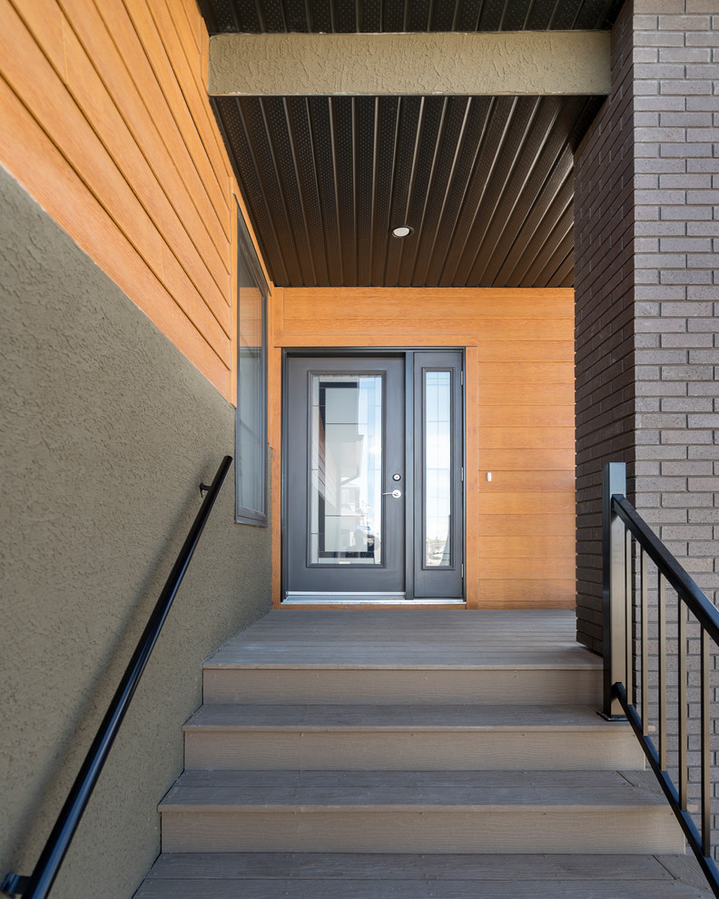 Réalisation d'une façade de maison verte design de plain-pied avec un revêtement mixte et un toit en shingle.