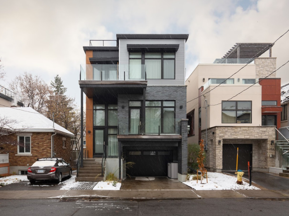 Photo of a medium sized and multi-coloured modern detached house in Ottawa with three floors, mixed cladding and a flat roof.