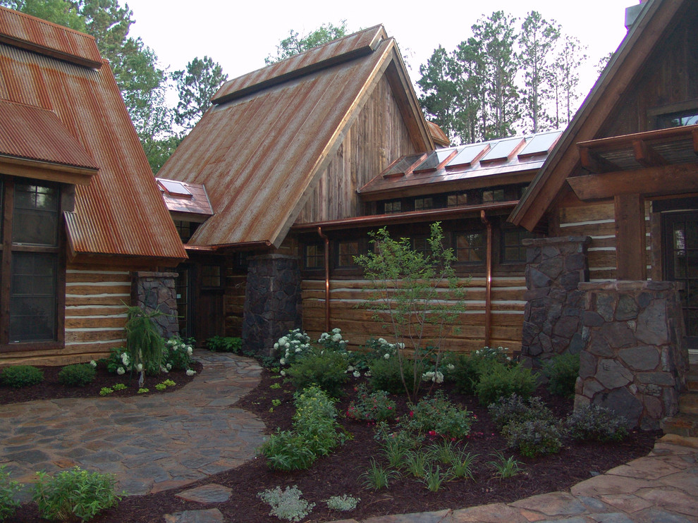 Стильный дизайн: деревянный, коричневый дом в стиле рустика с двускатной крышей - последний тренд