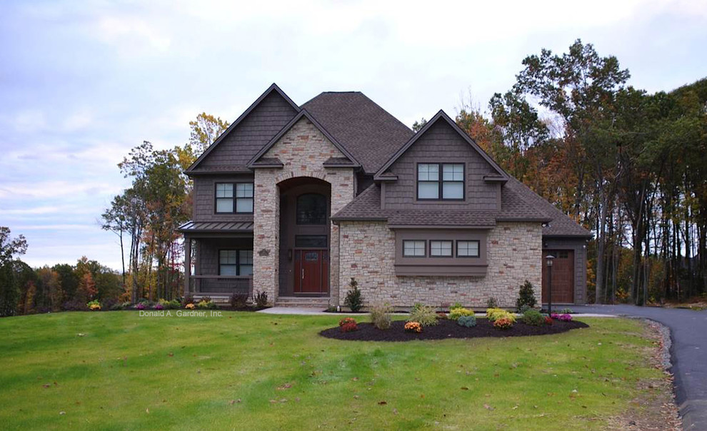 Example of a large arts and crafts brown two-story mixed siding exterior home design in Other with a hip roof
