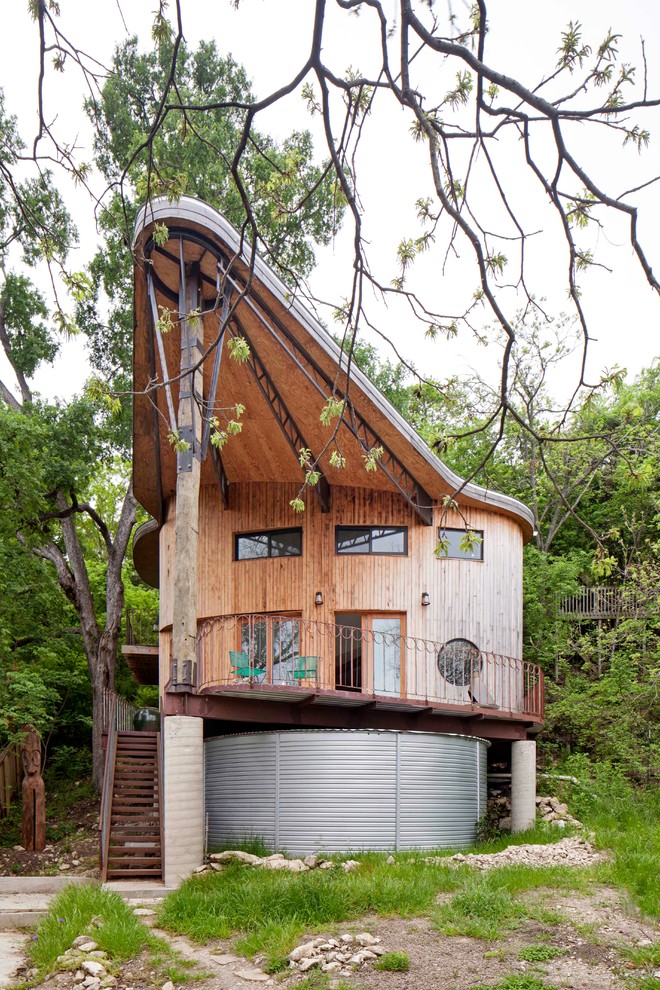 Design ideas for a bohemian house exterior in Austin with wood cladding.
