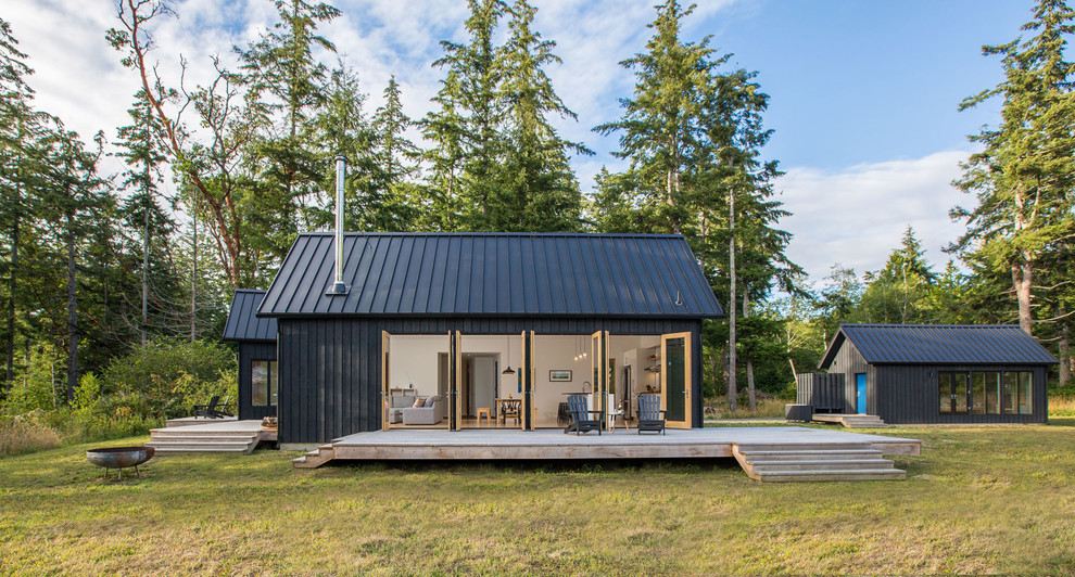 This is an example of a rustic bungalow house exterior in Seattle with wood cladding and a pitched roof.